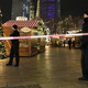 Police guard the market after the incident. Photo via AP